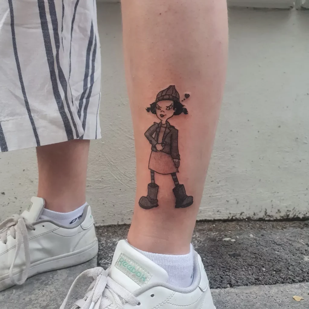 the cartoon figure "spinelli" as a tattoo on leg. Spinelli is holding a lighter.